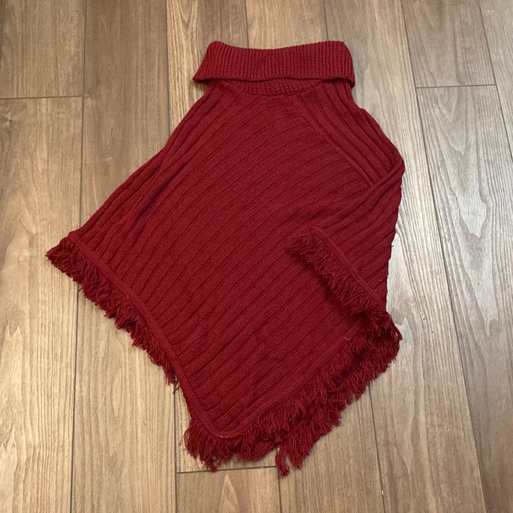 Tog Shop knit turtleneck poncho, wine-red in color, fringed on bottom. One size